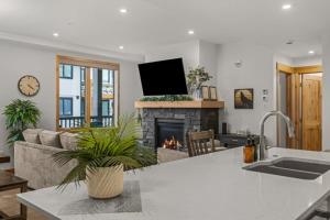 a living room with a couch and a fireplace at Luxury Mountain Haven Views Hot Tub Central Bridgette Bar Main St in Canmore