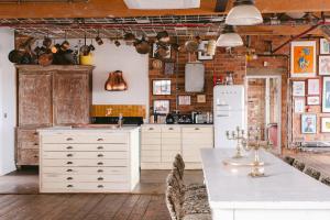 a kitchen with white cabinets and a white refrigerator at Jason Works in Loughborough