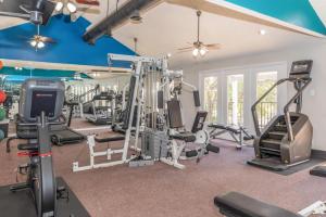 a gym with treadmills and machines in a room at District West 2BR near shopping & dining in Lubbock