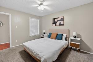 a bedroom with a bed and a ceiling fan at District West 2BR near shopping & dining in Lubbock +12 photos