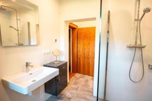 a bathroom with a sink and a shower at Haus Uschi in Klagenfurt +55 photos