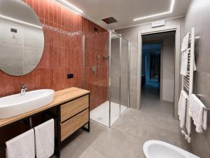 a bathroom with a sink and a shower at Eos Lake House Luxury in Limone sul Garda +24 photos