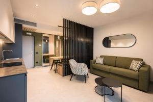 a living room with a couch and a table at Eos Lake House Luxury in Limone sul Garda