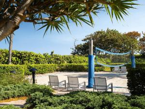 a group of chairs and a net in a park at Ocean Pointe Resort One-Bedroom Villa in Palm Beach Shores