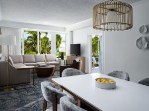 a living room with a table and chairs at Ocean Pointe Resort Two-Bedroom Villa in Palm Beach Shores