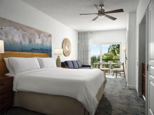 a bedroom with a large bed and a living room at Ocean Pointe Resort Two-Bedroom Villa in Palm Beach Shores +35 photos