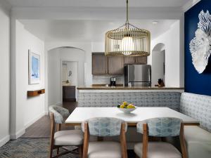 a kitchen and dining room with a table and chairs at Ocean Pointe Resort Two-Bedroom Villa in Palm Beach Shores
