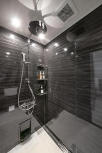 a bathroom with a shower with a glass door at T-home彩 in Tokyo +46 photos