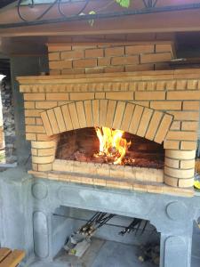 a brick oven with a fire in it at Guest house Hasmik in Yeghegnadzor