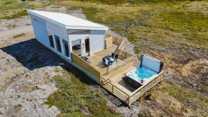 an overhead view of a tiny house with a swimming pool at Hvammur 10 with private hot tub in Kaldrananes