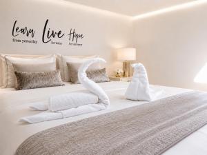 a white bed with two swans made out of towels at Vila Matt in Vama Veche +12 photos