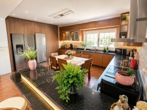 a kitchen with a table and a dining room at A Casa dos Sonhos in Chaves