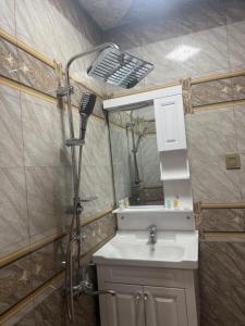 a bathroom with a shower and a sink at Mountain-city in Zaqatala +39 photos