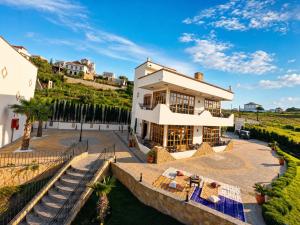 an aerial view of a house with a patio and stairs at Oussoul House in Feddane Saïdi