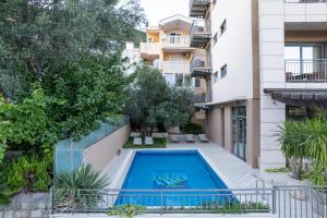 an apartment with a swimming pool in a building at Hotel Petrovac in Petrovac na Moru