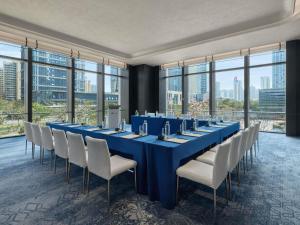 a long blue table and chairs in a room with windows at Fairmont Xiamen in Xiamen +91 photos