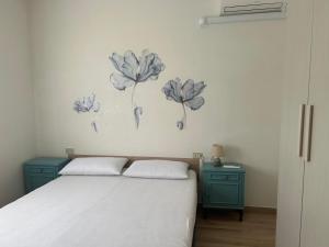a bedroom with a bed and two blue night stands at MareMare Follonica in Follonica +1 photo