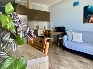 a living room with a couch and a dining room at Sea Towers 2 room apartment in Batumi