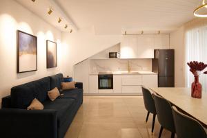 a living room with a couch and a table at GABRIEL APARTMENTS - Jacuzzi & Panoramic JLM View Steps to Shaare Zedek Hospital in Bayit Wegan