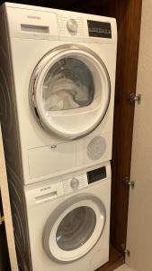 a washing machine and a dryer in a room at GABRIEL APARTMENTS - Jacuzzi & Panoramic JLM View Steps to Shaare Zedek Hospital in Bayit Wegan