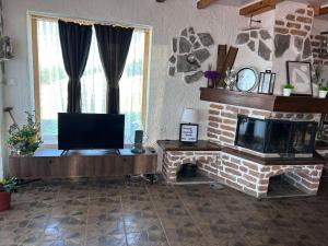 a living room with a fireplace and a flat screen tv at Kompleks MINAMI in Ohrid