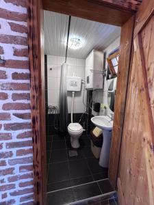 a small bathroom with a toilet and a sink at Kompleks MINAMI in Ohrid +70 photos