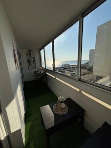 a room with a table and a view of the ocean at Saint Hilaire sea view accommodation in Saint-Hilaire-de-Riez +3 photos