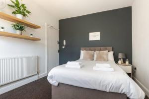 a bedroom with a large white bed with two pillows at Doncaster Budget Room in Shared House w Kitchen in Doncaster