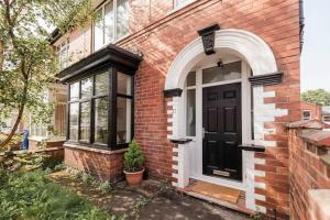 a brick house with a black door and a window at Doncaster Budget Room in Shared House w Kitchen in Doncaster