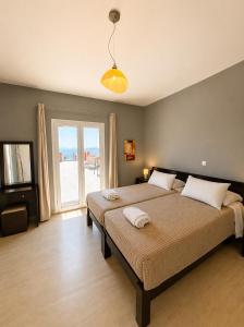 a bedroom with a large bed and a large window at Alexandra Apartment in Ipsos