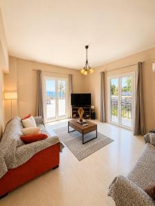 a living room with a couch and a table at Alexandra Apartment in Ipsos