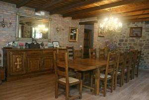 a dining room with a wooden table and a mirror at Casa de Aldea Los Valles in La Llera