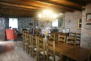 a dining room with a large wooden table and chairs at Casa de Aldea Los Valles in La Llera