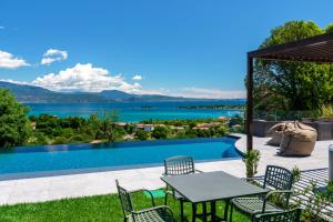 a patio with a table and chairs next to a swimming pool at Casa Veronica in Manerba del Garda