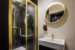 a bathroom with a sink and a shower and a mirror at The Clyffe Hotel in Lowestoft +91 photos