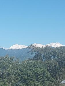 a mountain range with snow capped mountains in the background at Kadamba Bnb Homestay in Kurseong