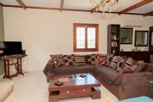 a living room with a couch and a coffee table at Mystras Balcony View in Mystras