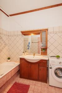 a bathroom with a sink and a washing machine at Mystras Balcony View in Mystras +30 photos