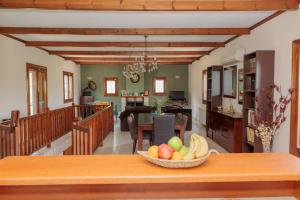 a kitchen and living room with a bowl of fruit on a table at Mystras Balcony View in Mystras