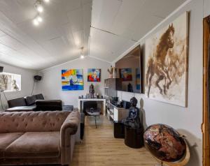a living room with a couch and a desk at Tjarnarkot in Sandgerði