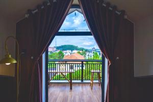 a room with a view of a balcony with a window at Luxury Hotel Dalat in Xuan An +32 photos
