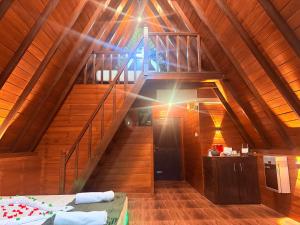 a attic room with a staircase in a house at Rainforest Emerald Haven in Deniyaya