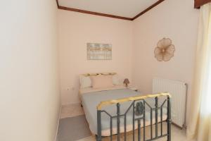 a bedroom with a bed in a white room at Mystras Balcony View in Mystras