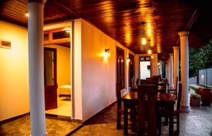 a dining room with a wooden ceiling and a table at Zenora Villa ella in Ella