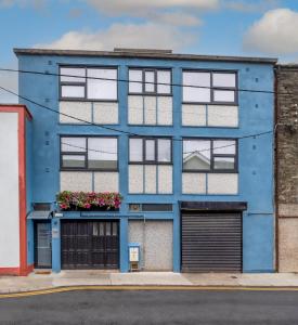 a blue building with windows and a garage at Clanbrassil Townhouse in Dundalk