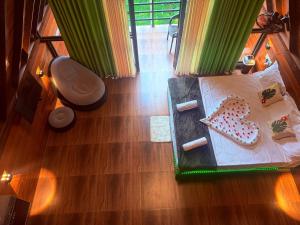 an overhead view of a bed with a cake on it at Rainforest Emerald Haven in Deniyaya