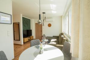 a living room with a white table and chairs at Apartment Center Korzo 2 in Bihać