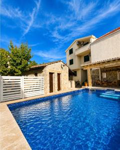 a swimming pool in the backyard of a house at Villa Fortuna in Mostar