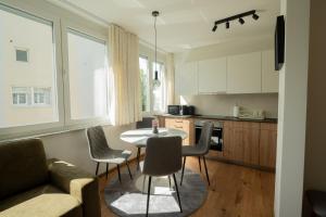 a kitchen and dining room with a table and chairs at Apartment Center Korzo 2 in Bihać
