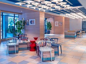 a restaurant with chairs and tables in a lobby at ibis Styles Kuala Lumpur Bukit Bintang in Kuala Lumpur